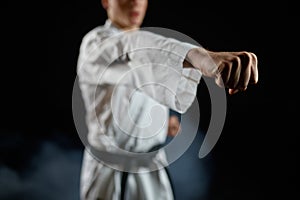 Male karateka, fighter practice in white kimono
