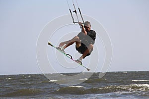 Male kitesurfer boosting big air photo