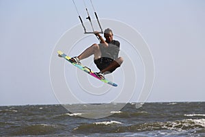 Male kitesurfer boosting big air photo