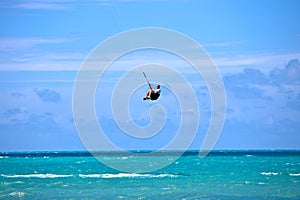 Male Kitesurfer grabing his board