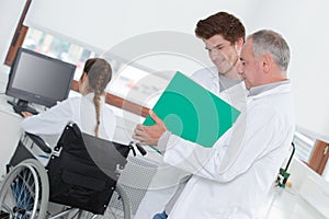 Male lab workers writing down observations in laboratory