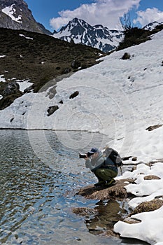 Male landscape photographer working on location on a shoot in the Swiss Alps near Klosters