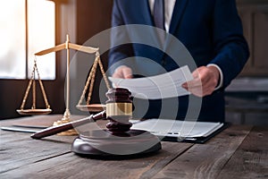 Male lawyer with contract papers and gavel in courtroom, justice concept