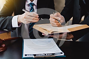 Male lawyer discuss to a legal document explaining the terms of a consultation with a businessman. before signing a contract with