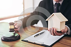 Male lawyer or judge hand`s striking the gavel on sounding block