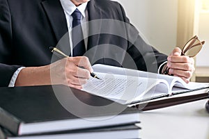 Male lawyer or judge working with Law books, gavel, report the c