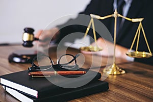 Male lawyer or judge working with Law books, gavel, report the c