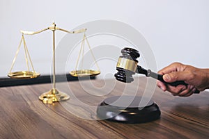 Male lawyer or judge working with Law books, gavel, report the c