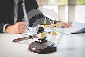 Male lawyer or judge working with Law books, gavel, report the c