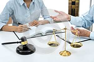 Male lawyer or notary consulting and discussion to businesswoman client in the office, Judge gavel with scales of justice