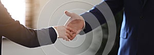Male lawyer shaking hands with client in office. Banner design