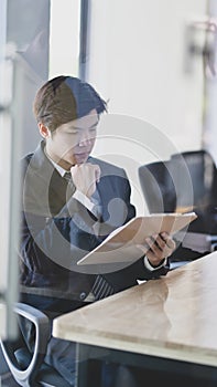 Male lawyer working on a laptop and providing legal document