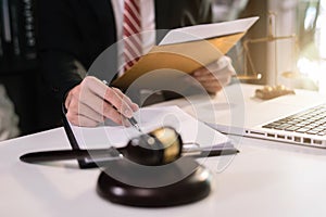 Male lawyer working at table at home office.