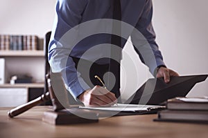 Male lawyer working at table in office