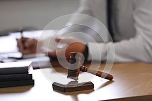 Male lawyer working at table, focus on gavel