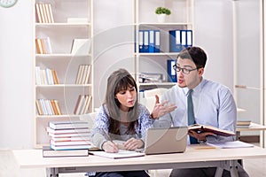 The male lecturer giving lecture to female student