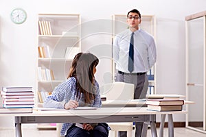 The male lecturer giving lecture to female student