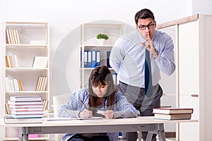 The male lecturer giving lecture to female student