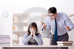 The male lecturer giving lecture to female student