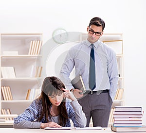 Male lecturer giving lecture to female student