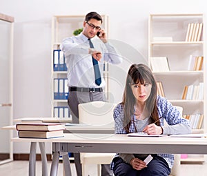 Male lecturer giving lecture to female student