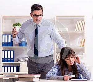 Male lecturer giving lecture to female student