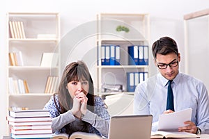 The male lecturer giving lecture to female student