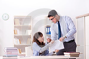 The male lecturer giving lecture to female student