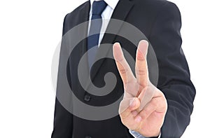 Male left hand in black suit makes cute scissors hand gesture