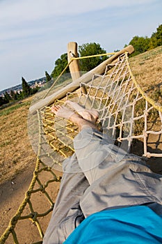 Male legs in a hammock