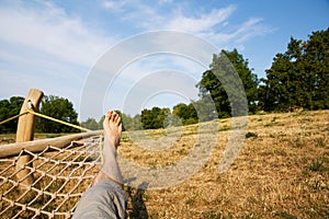 Male legs in a hammock