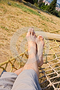 Male legs in a hammock