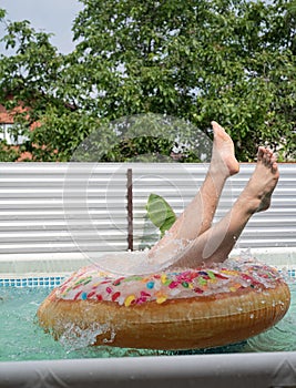 male legs in the inflatable swim ring