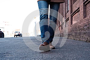 Male Legs In Jeans And Leather Boots Outdoor. Fashion Street Photo, color tone