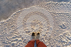 Male legs standing on scenic icy surface