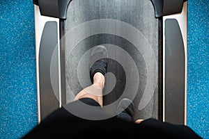 Male legs walking and running on treadmill in gym.  Exercising cardio workout