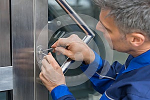 Male Lockpicker Fixing Door Handle At Home