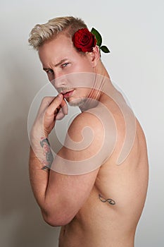 Male lover posing sensually with a flower