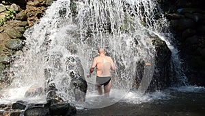 Male man in black shorts wash stream river water cascade flow