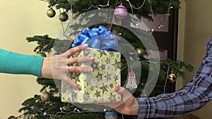 Male man hands yellow present gift box for female woman