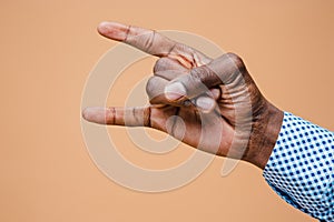 Male, man, hipster, in shirt, hand raised showing a heavy metal rock sign