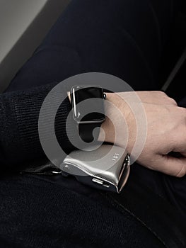 A male man with a smartwatch and the seatbelt