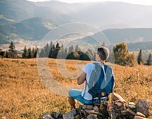 Male man traveler on the background of the Caucasian mountains