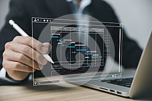 Male manager managing business planning project schedule in the office. Gantt chart showing on virtual screen. business people