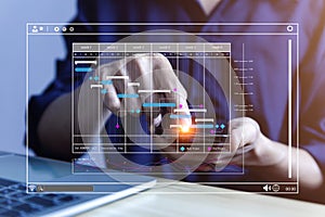 Male manager managing business planning project schedule in the office. Gantt chart showing on virtual screen. business people