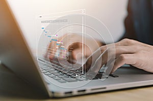 male manager using a laptop Manage business planning project schedules in office, showing Gantt charts on a virtual screen.