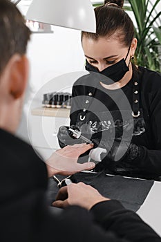 Male manicure. Close up view of the nail service master doing manicure for man photo