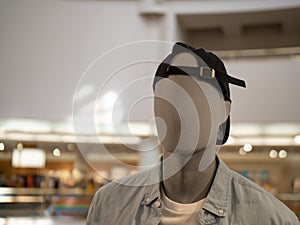 Male mannequin with backwards baseball cap in a department store