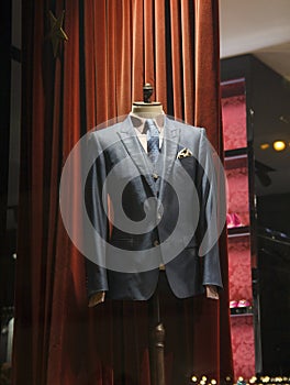 Male mannequin wearing a suit and accessories