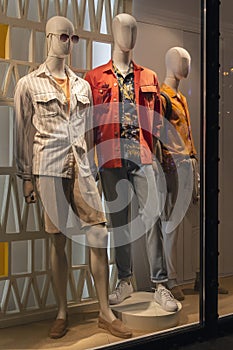 Male mannequins in elegant clothes in a shop window